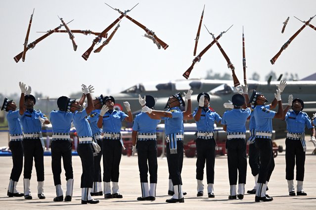 Indian Air force cadets toss their rifles during a full dress rehearsal ahead of MIG-21 Bison fighter jet farewell at Chandigarh Airforce Station on September 24, 2025. (Photo by Arun Sankar/AFP Photo)