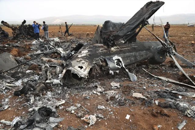 A wreckage of an American helicopter is seen in Afrin region, Syria, Thursday, February 3, 2022. After an overnight raid in northwest Syria. A U.S. official said one of the helicopters in the raid suffered a mechanical problem and was redirected to a site nearby, where it was destroyed. (Photo by Omar Albam/AP Photo)