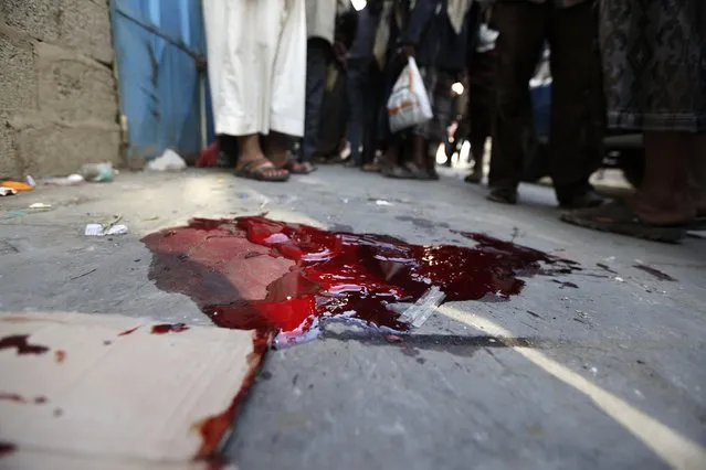 Blood stains are seen at the scene of an assassination of Faisal al-Sharif, a tribal chieftain loyal to the Shi'ite Houthi group, in Sanaa December 23, 2014. Al-Sharif was gunned down in a drive-by shooting, local media reported. (Photo by Khaled Abdullah/Reuters)