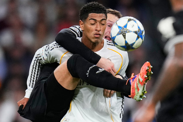 Juventus' Teun Koopmeiners, right, challenges Real Madrid's Jude Bellingham during the Champions League opening phase soccer match between Real Madrid and Juventus in Madrid, Spain, October 22, 2025. (Photo by Manu Fernandez/AP Photo)