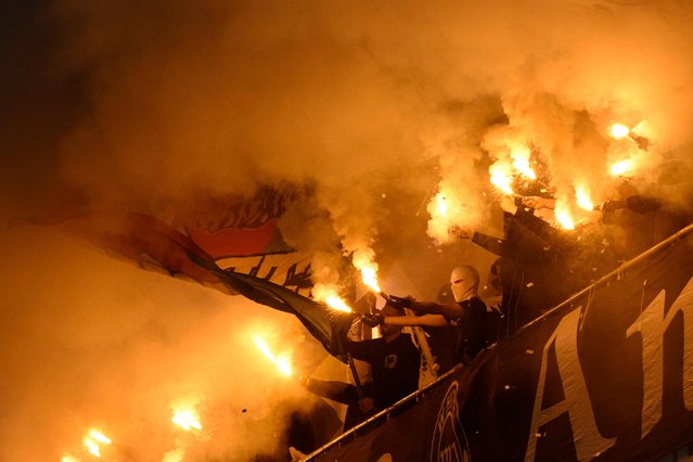 Vitoria Guimaraes's fans burn flares during the Portuguese League football match between Vitoria Guimaraes SC and SL Benfica at Dom Afonso Henriques stadium in Guimaraes on November 1, 2025. (Photo by Miguel Riopa/AFP Photo)