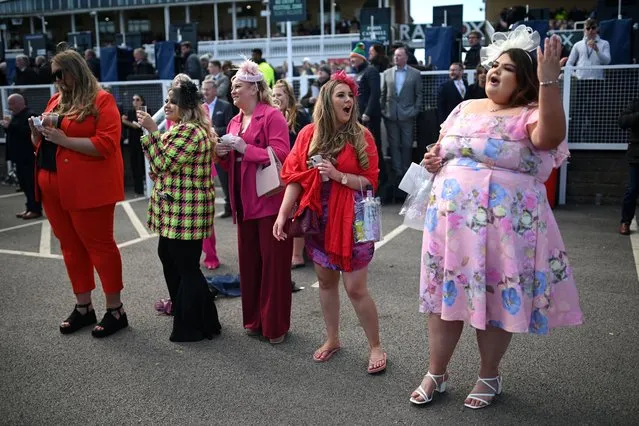 Racegoers attend the opening day of the Grand National Festival horse race meeting at Aintree Racecourse in Liverpool, north-west England, on April 13, 2023. (Photo by Oli Scarff/AFP Photo)