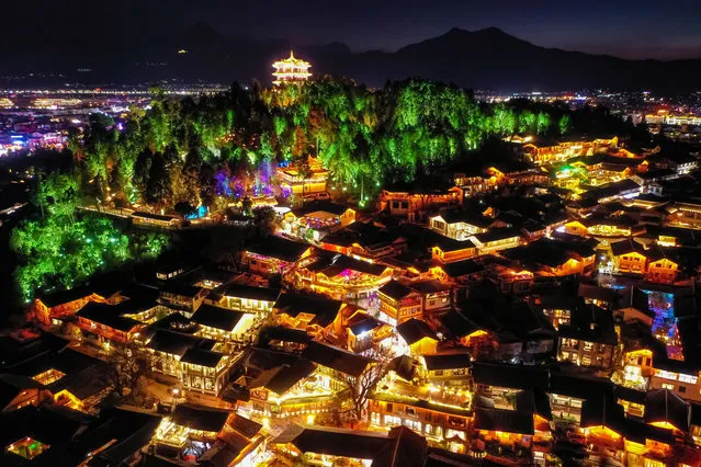 Aerial view of illuminated Lijiang Old Town at night on April 16, 2023 in Lijiang, Yunnan Province of China. (Photo by VCG/VCG via Getty Images)