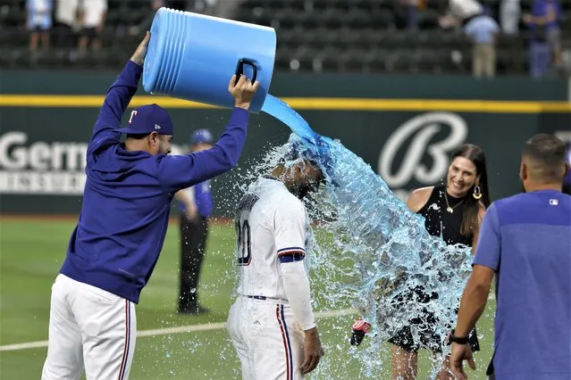 Texas Rangers' Martin Perez dunks Ezequiel Duran (20) after they defeated the Arizona Diamondbacks during a baseball game, Tuesday, May 2, 2023, in Arlington, Texas. (Photo by Michael Ainsworth/AP Photo)