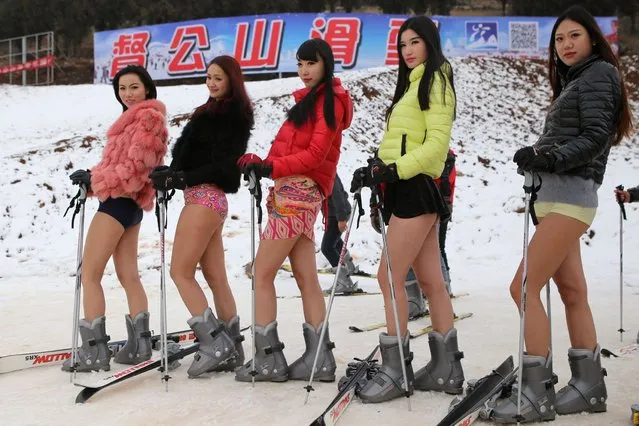 Young women wearing no trousers pose for a photo on the ski slopes at a ski resort in Xuzhou, in east China's Jiangsu province on January 13, 2015 in a promotional effort to equal “No Pants Subway Ride”, which was marked on January 11 this year. (Photo by AFP Photo)