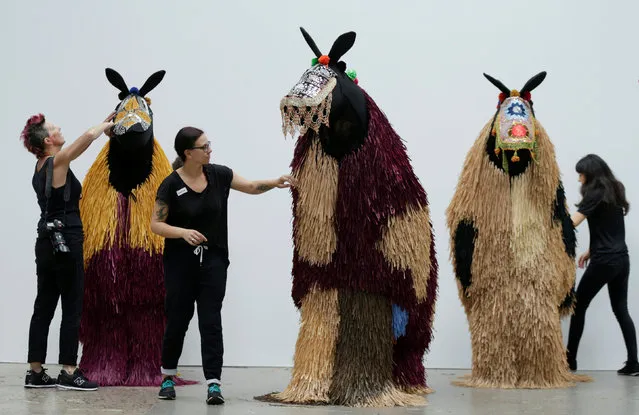 Dressers make last minute adjustments to the costumes of dancers performing as horses during a press preview of American artist Nick Cave's first major work shown in Australia, entitled HEARD.SYD in Sydney, November 8, 2016. (Photo by Jason Reed/Reuters)