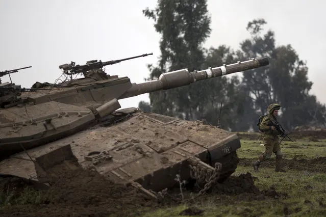 An Israeli soldiers of the Golani brigade trains in the Israeli controlled Golan Heights, near Israel-Syria border, Monday, January 19, 2015. The Lebanese militant Hezbollah on Monday prepared to bury six core fighters killed in Syria the day before in what the group described as an Israeli airstrike, including the son of a slain Hezbollah military chief – the group's most prominent figure to die so far in the conflict next door. (Photo by Ariel Schalit/AP Photo)