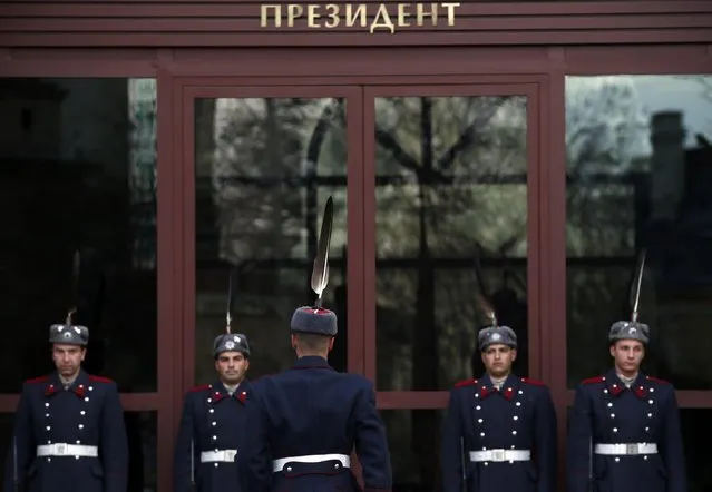A Bulgarian guard of honor changes shifts in front of a presidency building in downtown Sofia, Bulgaria, Saturday, November 12, 2016. Bulgarians vote Sunday to choose their new president in a contested runoff that has become a referendum on the fate of the country's center-right government. (Photo by Darko Vojinovic/AP Photo)
