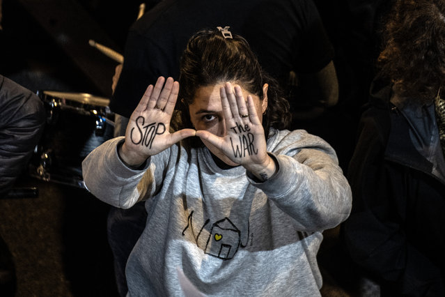 A demonstrator shows her hands reading “Stop the War” as relatives of Israeli hostages in Gaza gather in front of the Ministry of Defense to hold demonstration demanding a ceasefire and a hostage swap agreement in Gaza, on December 28, 2024, in Tel Aviv, Israel. (Photo by Mostafa Alkharouf/Anadolu via Getty Images)