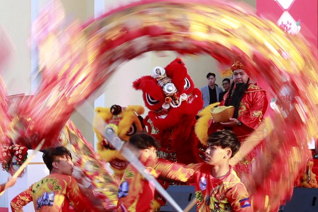 Dancers perform the traditional Chinese dragon dance outside a Chinese Association ahead of the upcoming Lunar New Year in Phnom Penh, Cambodia, 18 January 2025. The Lunar New Year, also known as Spring Festival in China and Tet in Vietnam, falls on 29 January, marking the beginning of the Year of the Snake. (Photo by Kith Serey/EPA/EFE)