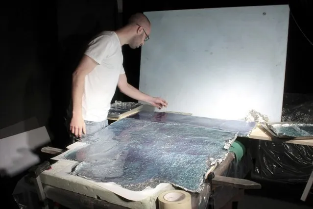 Matthew creates the ocean surface for his model, “Paradise”, made out of cooked sugar. (Photo by Matthew Albanese/Barcroft Media)