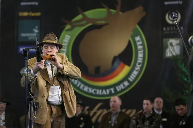 A competitor uses a specially designed instrument at the German championships in Deer-Calling at the “Jagd & Hund” exhibition in Dortmund February 6, 2015. (Photo by Ina Fassbender/Reuters)