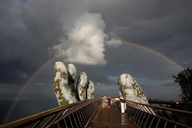 A double rainbow appears above giant hands structure on the Gold Bridge on Ba Na hill near Danang city, Vietnam on August 1, 2018. (Photo by Reuters/Kham)