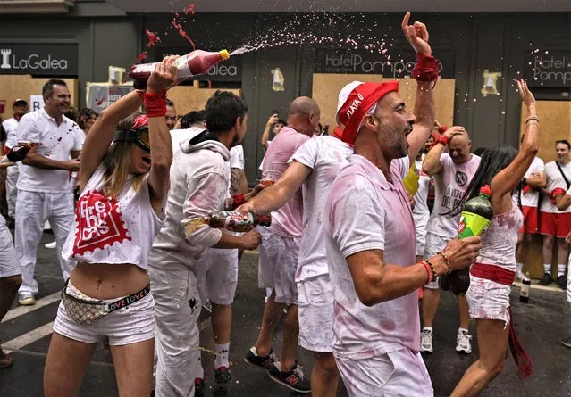Revellers gather for the “Chupinazo” rocket, which marks the official opening of the 2023 San Fermín fiestas in Pamplona, Spain, Thursday, July 6, 2023. (Photo by Alvaro Barrientos/AP Photo)