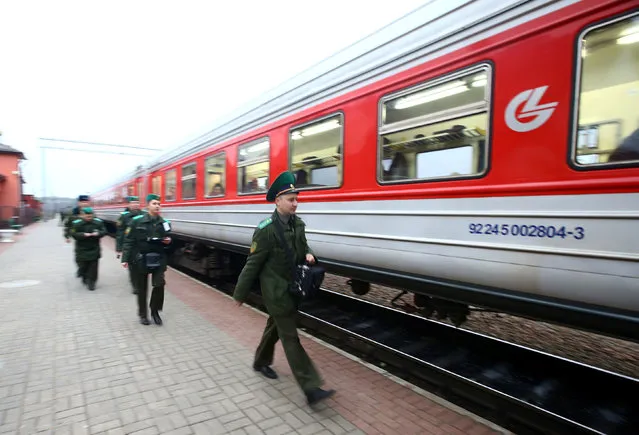 Belarussian border guards go to a train to check passengers' passports after they arrived from Lithuania, at the railway station Gudogai, Belarus, November 22, 2016. (Photo by Vasily Fedosenko/Reuters)