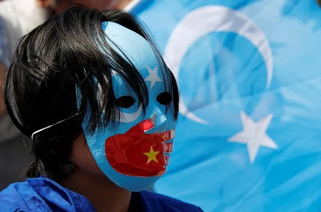 Ethnic Uyghur demonstrators take part in a protest against the visit of Chinese Foreign Minister Wang Yi to the Turkish capital, near the Chinese consulate in Istanbul, Turkey on July 26, 2023. (Photo by Dilara Senkaya/Reuters)