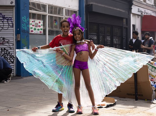 Young siblings in costume fully embrace the Notting Hill carnival atmosphere in London, England on August 28, 2023. (Photo by Nico Froehlich/The Guardian)