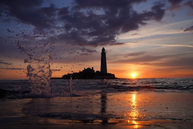 The sunrises at 04.25am at St Mary's Lighthouse in Whitley Bay, on the North East coast of England on Tuesday, June 20, 2023, the day before Summer Solstice – the longest day of the year. (Photo by Owen Humphreys/PA Images via Getty Images)