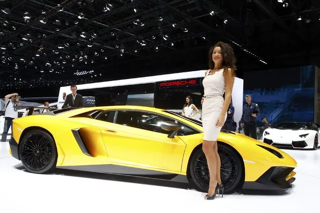 A model poses next to a Lamborghini Aventador SV sports car during the second press day ahead of the 85th International Motor Show in Geneva March 4, 2015. REUTERS/Arnd Wiegmann