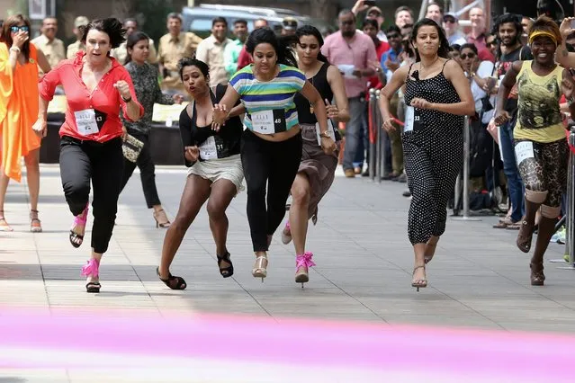 Women take part in India’s first ever “Stilleto Run”, organised by women's fashion brand Elle, on International Women’s Day in Bangalore on March 8, 2015. International Women's Day is marked on March 8 every year and is a global day celebrating the economic, political and social achievements of women past, present and future. (Photo by Manjunath Kiran/AFP Photo)