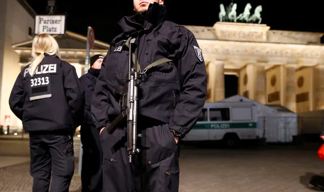 German police provide security at the Brandenburg Gate, ahead of the upcoming New Year's Eve celebrations in Berlin, Germany December 27, 2016. (Photo by Fabrizio Bensch/Reuters)