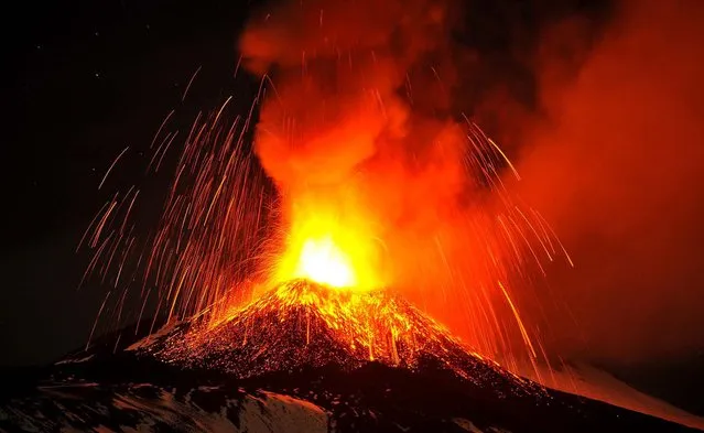 Mt. Etna spews lava during an eruption as seen from Acireale. (Photo by Carmelo Imbesi/Associated Press)