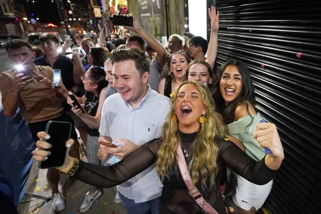 Excited revellers in Leeds, United Kingdom on July 18, 2021 described the midnight reopening of nightclubs as “like New Year” as they queued up for their first night out dancing since the start of the pandemic. (Photo by Ioannis Alexopoulos/PA Wire Press Association via Getty Images)
