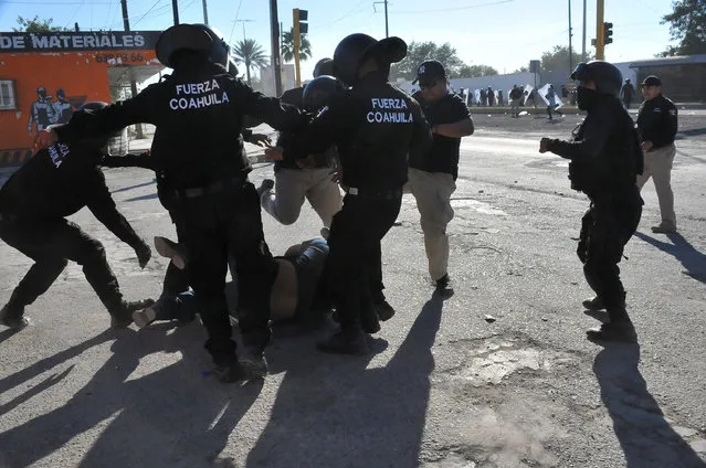Policemen kick a demonstrator on the floor during a protest against the rising prices of gasoline enforced by the Mexican government, in Monclova, in Coahuila state, Mexico, January 5, 2017. (Photo by Fidencio Alonso/Reuters/Courtesy of Zocalo de Monclova)