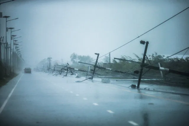 Fallen electricity poles are seen along a road as tropical storm Pabuk approaches the southern province of Nakhon Si Thammarat, Thailand, January 4, 2019. (Photo by Krittapas Chaipimon/Reuters)