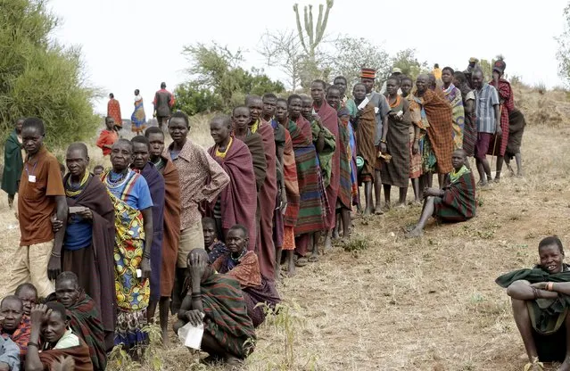 People from Karamojong tribe wait in line to vote at a polling station during elections in a village near the town of Kaabong in Karamoja region, Uganda February 18, 2016. (Photo by Goran Tomasevic/Reuters)