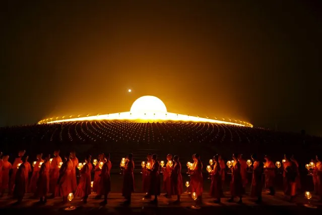 Buddhist monks pray at Wat Phra Dhammakaya temple during a ceremony on Makha Bucha Day in Pathum Thani province, north of Bangkok February 22, 2016. (Photo by Jorge Silva/Reuters)