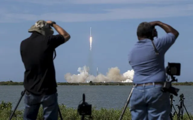 Photographers take pictures of the unmanned SpaceX Falcon 9 rocket with Dragon lifts off from launch pad 40 at the Cape Canaveral Air Force Station in Cape Canaveral, Florida April 14, 2015. (Photo by Scott Audette/Reuters)