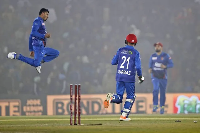 Mujeeb Ur Rahman, left, and Rahmanullah Gurbaz of Afghanistan celebrate the wicket of Shubman Gill of India during the first T20 cricket match between India and Afghanistan in Mohali, India, Thursday, January 11, 2024. (Photo by Surjeet Yadav/AP Photo)