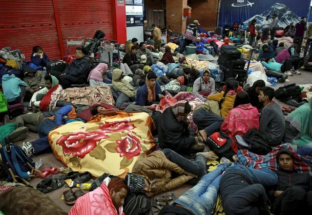 People wait outside the departure terminal at the airport in Kathmandu, Nepal, April 27, 2015, following the April 25 earthquake. (Photo by Danish Siddiqui/Reuters)