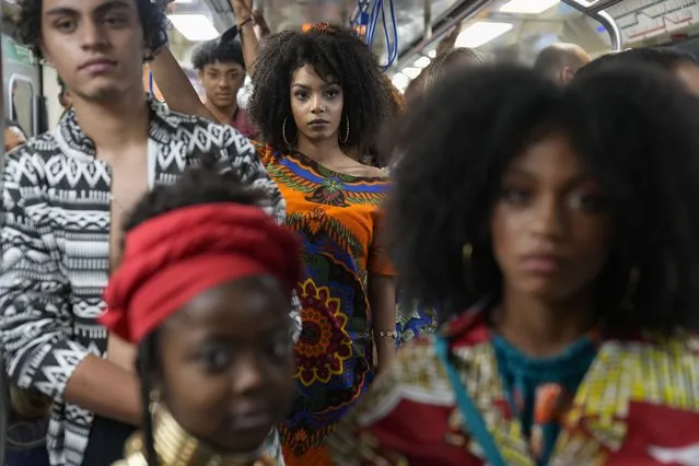 Models wear outfits designed by students from Afro-Brazilian communities at a subway station as part of Black Consciousness Awareness Month, in Sao Paulo, Brazil, November 19, 2021. In Brazil, more than half the population self-identifies as Black or biracial. (Photo by Andre Penner,/AP Photo)
