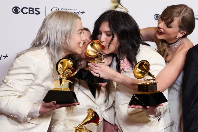 Phoebe Bridgers, Lucy Dacus, and Julien Baker of boygenius pose with the Best Alternative Music Album award, the Best Rock Song award and the Best Rock Performance award accompanied by Taylor Swift during the 66th Annual Grammy Awards in Los Angeles on February 5, 2024. (Photo by David Swanson/Reuters)
