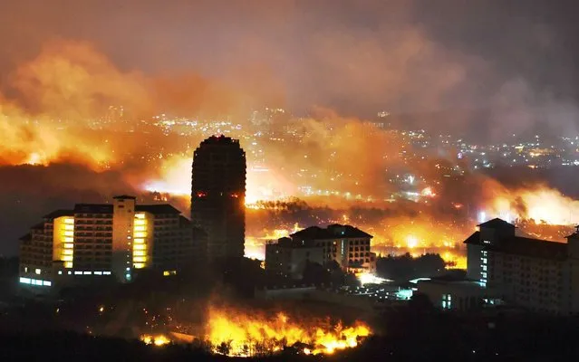 In this handout image provided by Kangwon Ilbo, A forest fire raging near a town on April 5, 2019 in Sokcho, South Korea. South Korea grappled with the massive blaze that roared through forests and cities along the eastern coast, declaring a national emergency and mobilizing all available resources to bring the inferno under control. (Photo by Kangwon Ilbo via Getty Images)