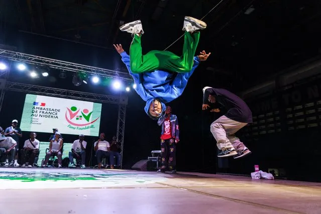 B-boy Bill does a backflip during his performance the National Breakdance Competition held at the National Stadium Surulere in Lagos on January 15, 2024. Breakdancing, or breaking, is making its debut as an Olympic sport this year and Nigeria's competitors have been vying to bring their own distinctive style to the games. (Photo by Benson Ibeabuchi/AFP Photo)