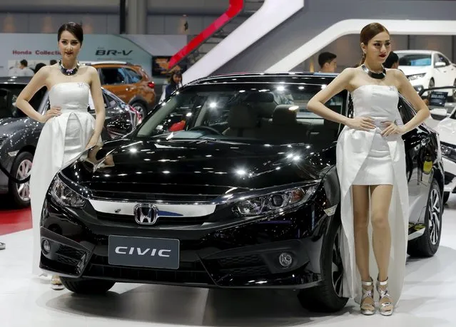 Models pose beside a Honda Civic car during a media presentation at the 37th Bangkok International Motor Show in Bangkok, Thailand March 22, 2016. (Photo by Chaiwat Subprasom/Reuters)