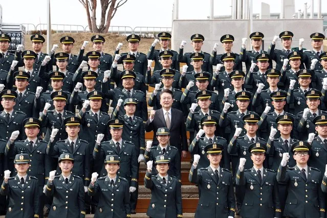South Korean President Yoon Suk Yeol (C, 3rd row) poses for a photo with Reserved Officer Training Corps cadets during their commissioning ceremony at the Army Cadet Military School in Goesan, South Korea, 28 February 2024. (Photo by Yonhap/EPA/EFE)