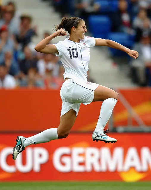 Carli Lloyd of USA celebrates scoring the third goal during the FIFA Women's World Cup 2011 Group C match between USA and Columbia at the Rhein Neckar Arena on July 2, 2011 in Sinsheim, Germany.  (Photo by Laurence Griffiths – FIFA/FIFA via Getty Images)