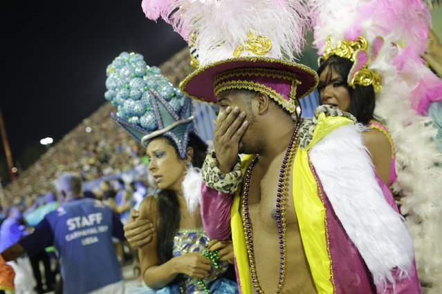 In this Tuesday, February 28, 2017 photo, performers from the Unidos da Tijuca samba school react after a float collapsed during Carnival celebrations at the Sambadrome in Rio de Janeiro, Brazil. Part of a float has collapsed during Rio de Janeiro's world famous Carnival parade, injuring at least four people, according to doctors at the scene. (Photo by Silvia Izquierdo/AP Photo)