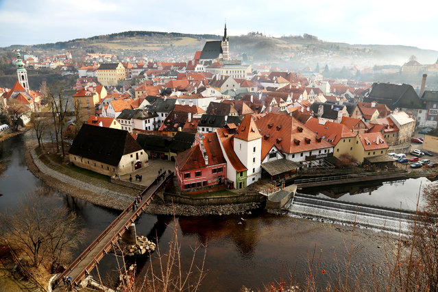 “Foggy small town”. This photo was captured at noon, 25 December 2013, from the castle which is located on the edge of the small town and is the perfect viewpoint for the panorama of the almost intact historical town.The fog and mist suffused and gave the town a sense of mystery. Photo location: Český Krumlov, South Bohemian, Czech Republic. (Photo and caption by Duowen Chen/National Geographic Photo Contest)
