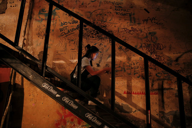 A girl uses her phone at Mao Live House during its last public concert night in central Beijing, China April 24, 2016. (Photo by Damir Sagolj/Reuters)