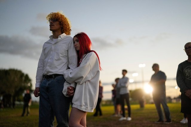 People listen to interfaith prayers during a community commemoration ceremony for the 17 students and staff of Marjory Stoneman Douglas High School who were killed at the Parkland, Fla., school, on the five-year anniversary of the shooting, Tuesday, February 14, 2023, at Pine Trails Park in Parkland. (Photo by Rebecca Blackwell/AP Photo)