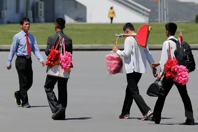 People carry props for an apparent parade to celebrate the Workers' Party of Korea (WPK) congress in central Pyongyang, North Korea May 8, 2016. (Photo by Damir Sagolj/Reuters)