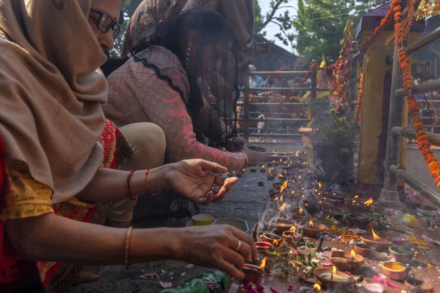 Kashmiri Hindu devotees light earthen lamps during the annual festival at the Kheer Bhawani Hindu temple in Tulla Mulla,, northeast of Srinagar, Indian controlled Kashmir, Friday, June 14, 2024. Hundreds of Hindu devotees attended the prayers in the historic Kheer Bhavani Temple during the annual festival dedicated to Hindu goddess Durga. (Photo by Dar Yasin/AP Photo)