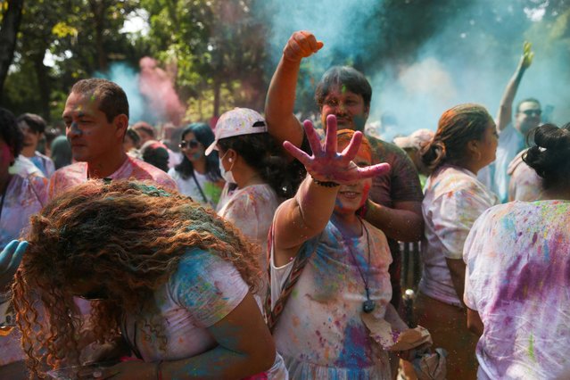 People take part in a symbolic Holi celebration organized by the Embassy of India, in San Salvador, El Salvador on March 4, 2023. (Photo by Jose Cabezas/Reuters)