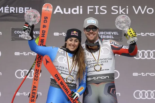 Italy's Sofia Goggia, left, and Norway's Aleksander Aamodt Kilde celebrate after winning the women's and men's downhill overall leaders cups, on the podium of an alpine ski, World Cup Finals downhill, in Courchevel, France, Wednesday, March 16, 2022. (Photo by Alessandro Trovati/AP Photo)