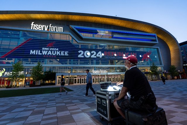 Darrin Bruce works on the exterior lighting on the Fiserv Forum ahead of the 2024 Republican National Convention, July 11, 2024, in Milwaukee. It can be hard for some to swallow that Milwaukee, the deepest blue swing state in Wisconsin, is playing host to former President Donald Trump. It didn't help smooth things over after Trump used the word “horrible” when talking about Milwaukee just a month before the convention. Still, Milwaukee officials point to the economic benefits and a chance to show off the city and Wisconsin to a national audience. (Photo by Alex Brandon/AP Photo)